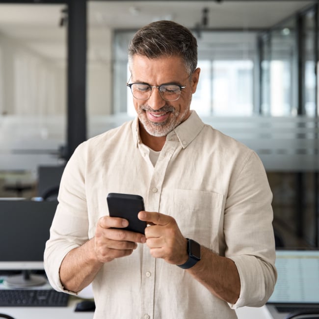 businessman smiling on his phone.