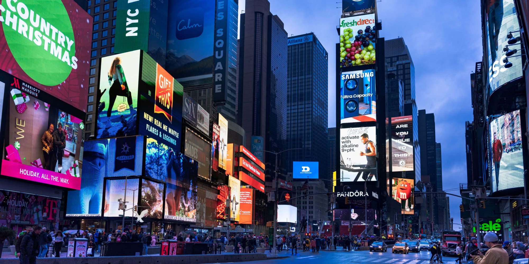 Bright digital billboards illuminate Times Square with vibrant advertisements and colorful graphics.