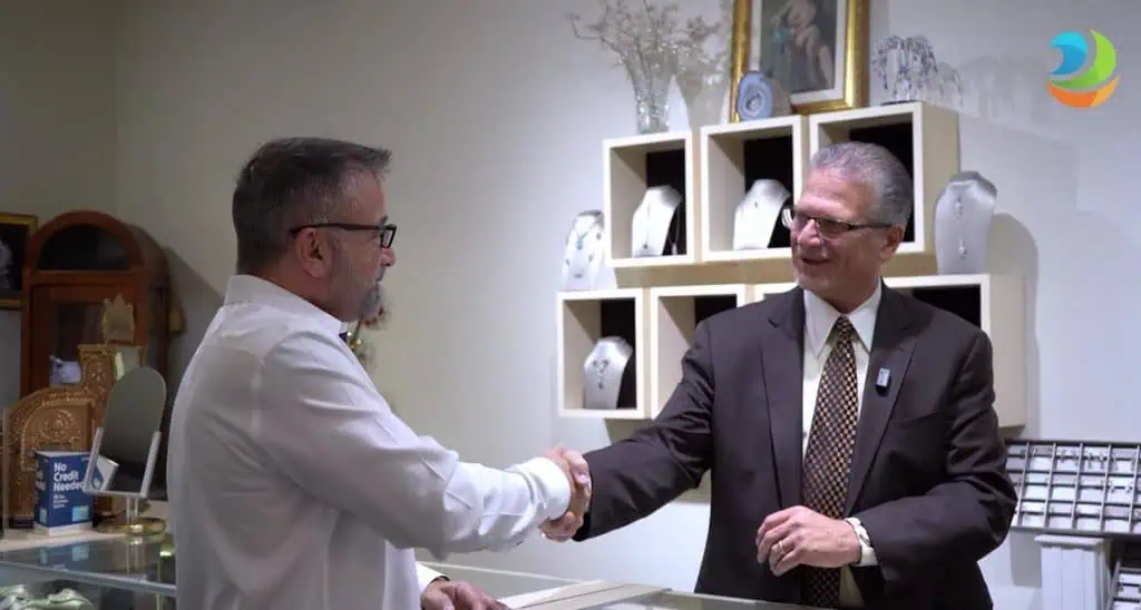 Elegant jewelry store handshake between two businessmen in a jewelry shop.