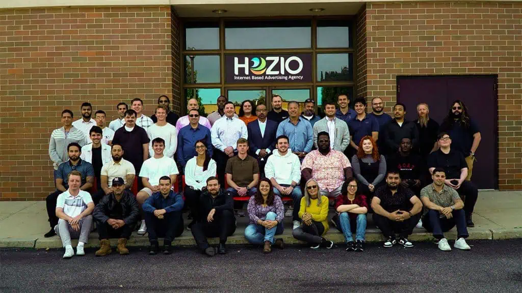 Hozio internet advertising agency team group photo outside building.